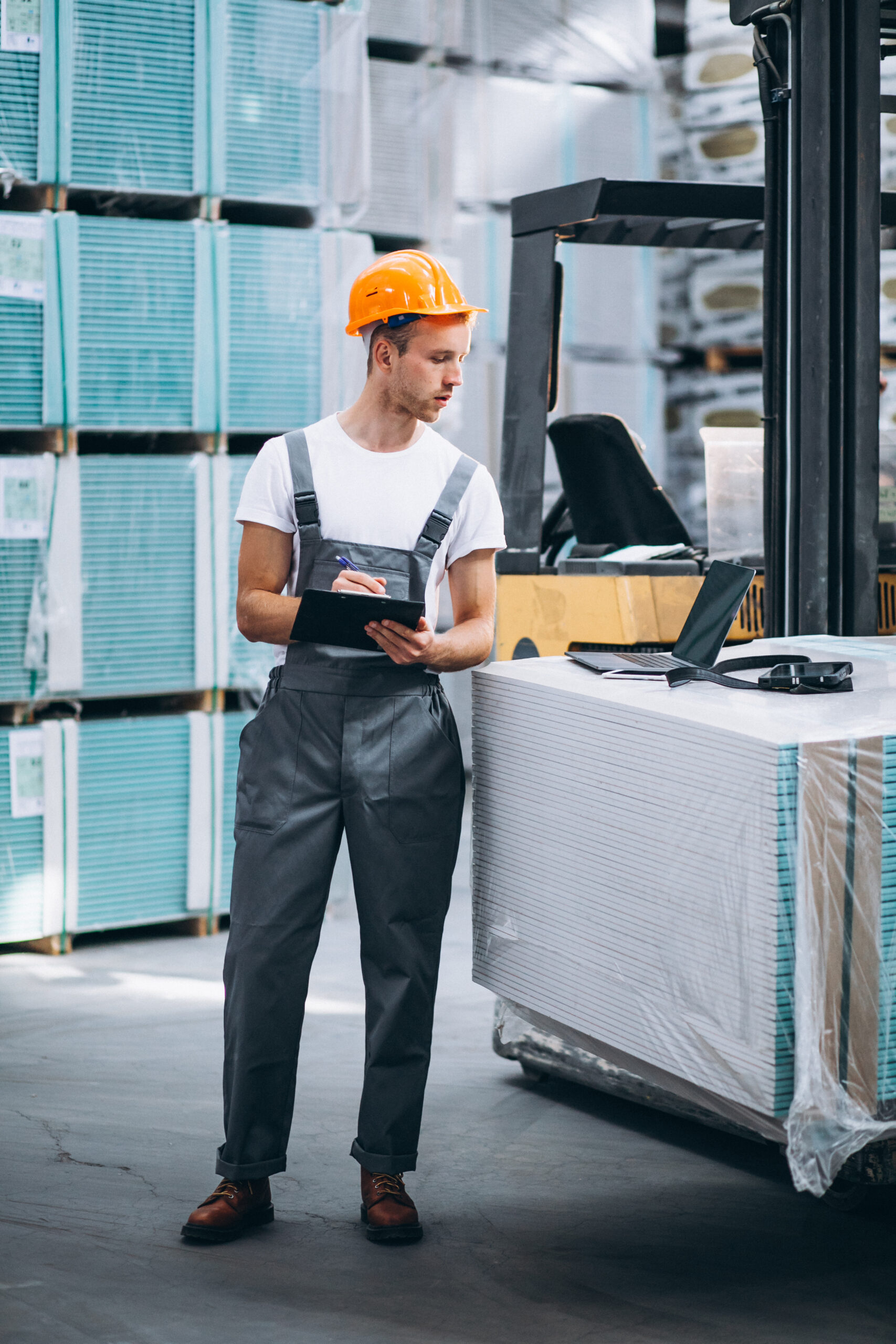 Young man working at a warehouse with boxes